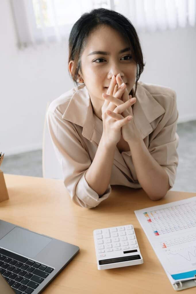 Portrait Young female accountant thinking for financial report in office.